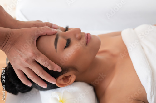 Close-up of a hand while being spa face massage. Thai massage for health