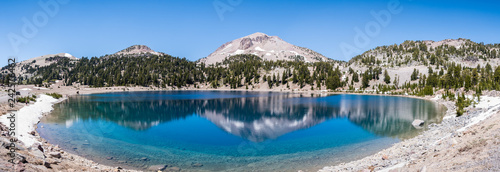 Surrounding mountains reflected in the calm waters of Lake Helen, Lassen Volcanic National Park, Northern California