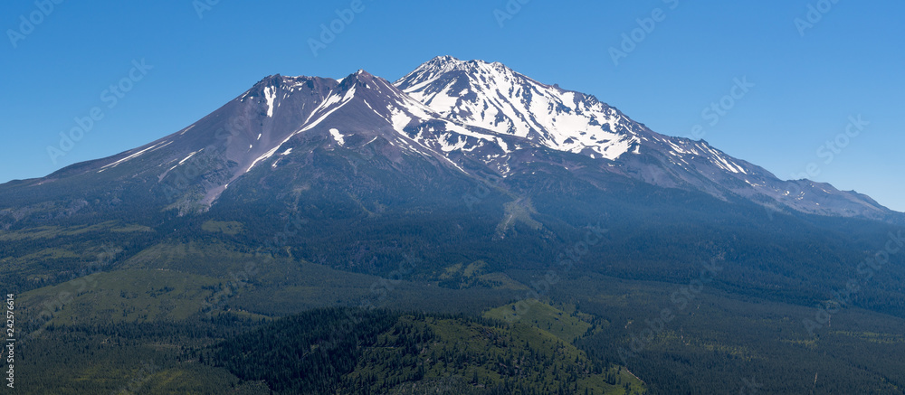 Panoramic view of the snow covered summit of Shasta mountain on a sunny summer day, California