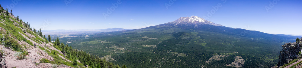 Panoramic view of the hiking trail to Black Butte's top and the forests and summit of Shasta mountain covered in snow; Siskiyou County, Northern California