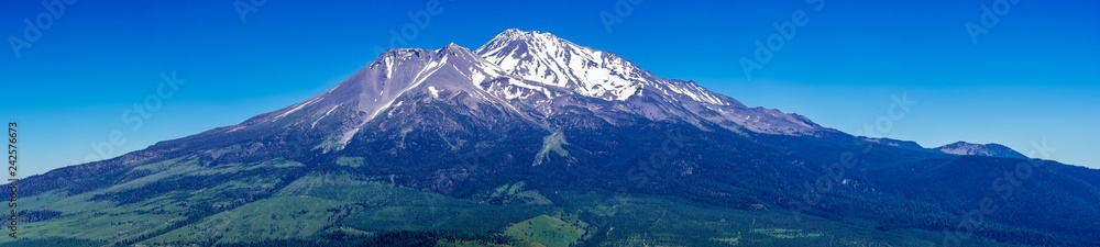 Panoramic view of the snow covered summit of Shasta mountain on a sunny summer day, California
