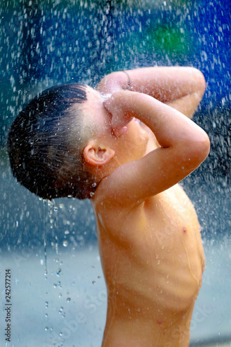 Kid boy playing with water during take shower © nitimongkolchai