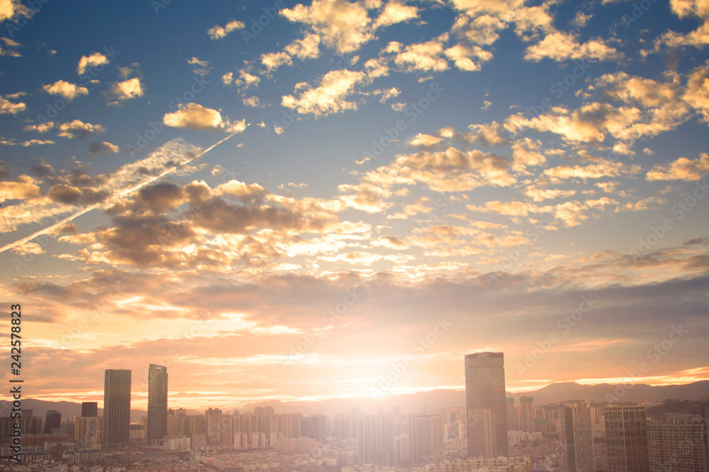 Urban real estate concept: city on twilight color sky and clouds cityscape background