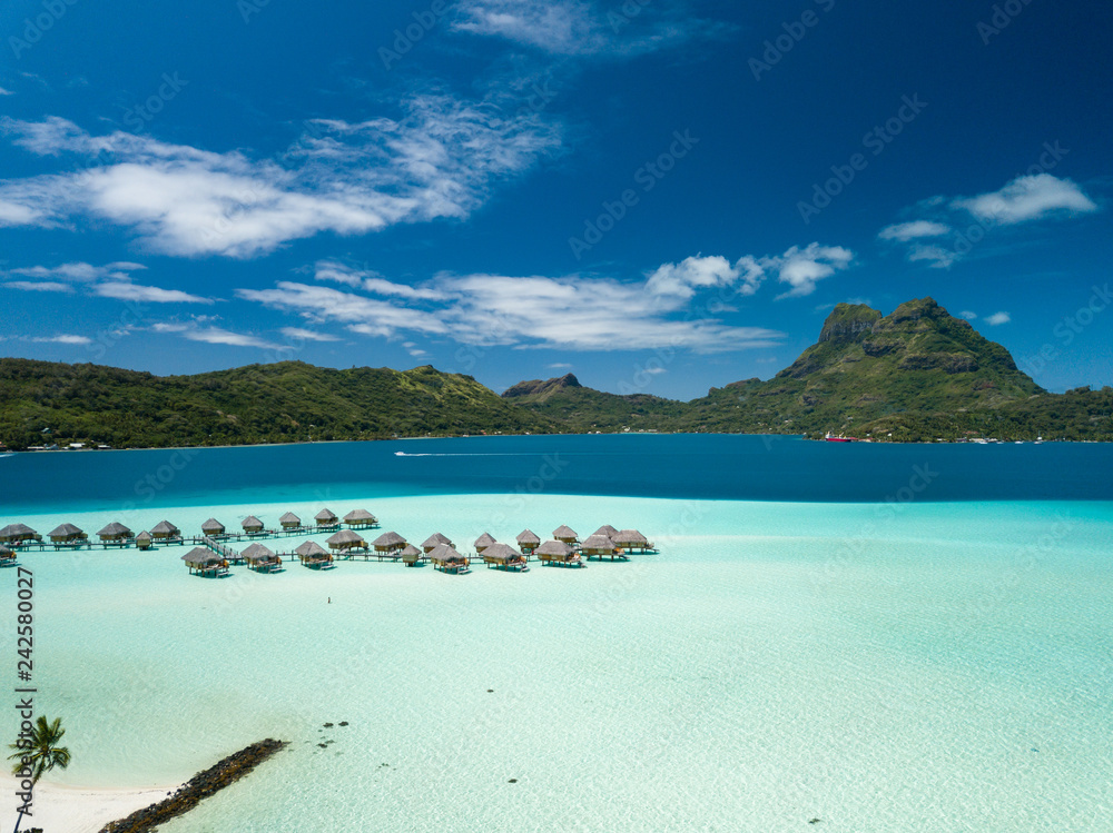 Aerial image from a drone of blue lagoon and Otemanu mountain at Bora Bora island, Tahiti, French Polynesia, South Pacific Ocean (Bora Bora Aerial). Aerial image from a drone of blue lagoon and Otemanu mountain at Bora Bora island, Tahiti, French Polynesia, South Pacific Ocean (Bora Bora Aerial).