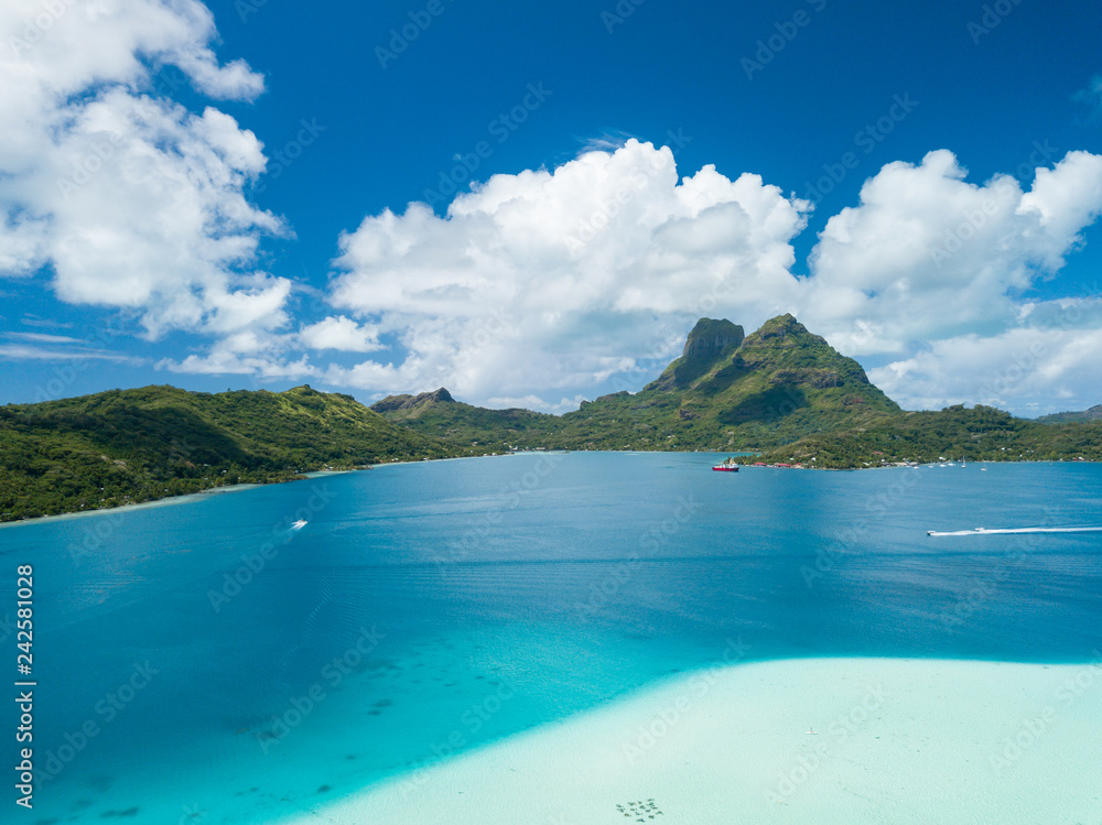 Aerial image from a drone of blue lagoon and Otemanu mountain at Bora Bora island, Tahiti, French Polynesia, South Pacific Ocean (Bora Bora Aerial). Aerial image from a drone of blue lagoon and Otemanu mountain at Bora Bora island, Tahiti, French Polynesia, South Pacific Ocean (Bora Bora Aerial).