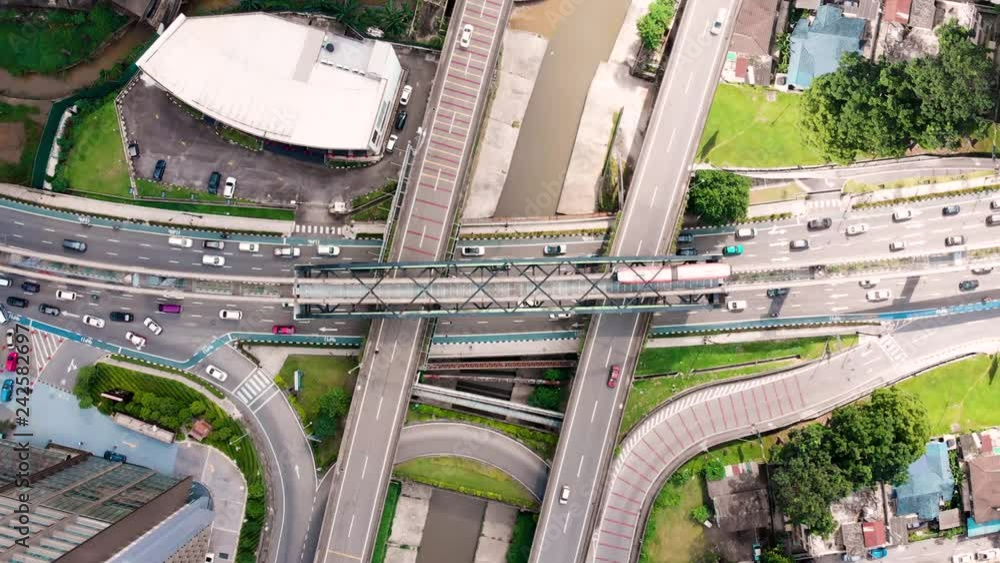 Aerial top view of city asphalt road with lot of vehicles or car traffic and buildings, modern urban intersections and junctions in midtown Aerial top view of city asphalt road with lot of vehicles or car traffic and buildings, modern urban intersections and junctions in midtown
