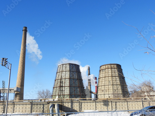 large pipes spew smoke from thermal power plants  BLUE SKY