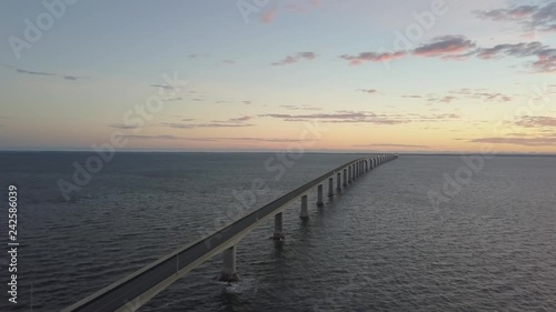 Aerial view of Confederation Bridge to Prince Edward Island during a vibrant sunny sunrise. Taken in Cape Jourimain National Wildlife Area, New Brunswick, Canada. photo