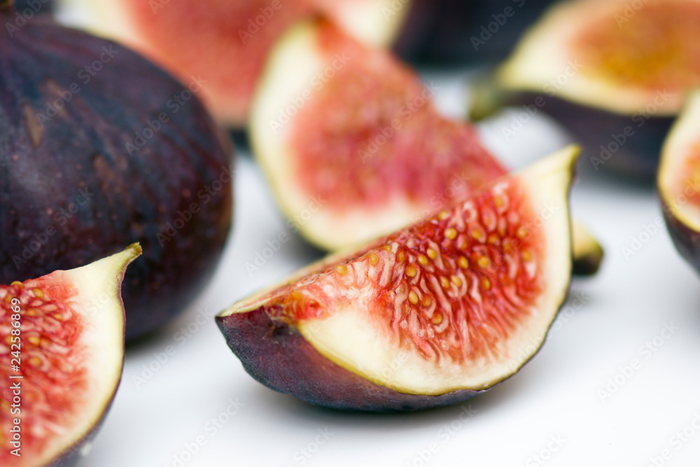 Figs whole and in pieces - fresh, juicy, tasty, sweet on a white background. macro Figs whole and in pieces - fresh, juicy, tasty, sweet on a white background. macro