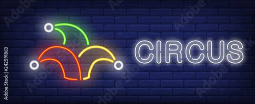 Circus neon text with jester hat. Circus performance advertisement design. Night bright neon sign, colorful billboard, light banner. Vector illustration in neon style.