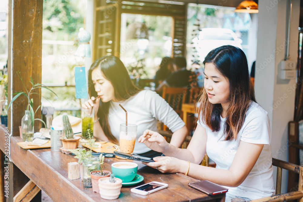 Smiling asian beautiful women drinking hot latte coffee Smiling asian beautiful women drinking hot latte coffee