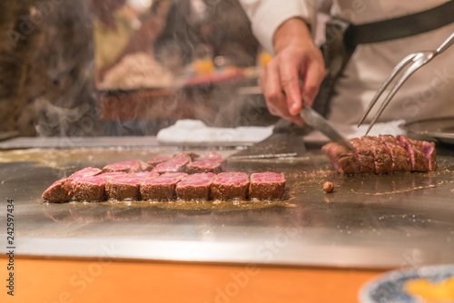 Chef hands cooking wagyu beef in Japanese restaurant photo