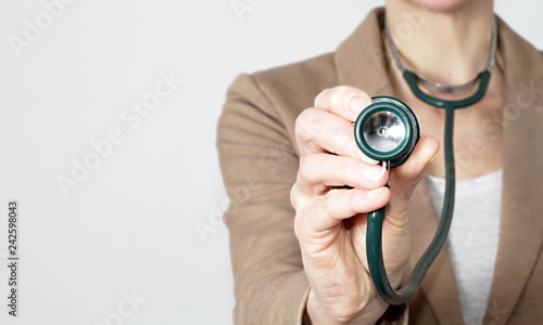 woman doctor with stethoscope on grey background stock photo photo