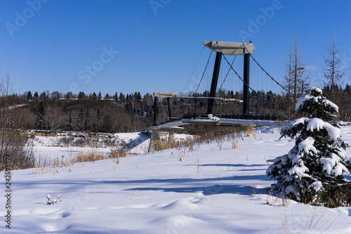 Fort Edmonton foot bridge in winter season sunny day with blue sky background