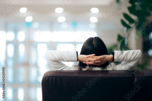 Relaxed Woman Sitting on a Couch in Waiting Room  photo