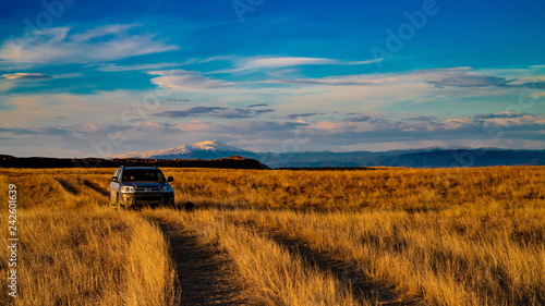 car on road with mountain on background photo