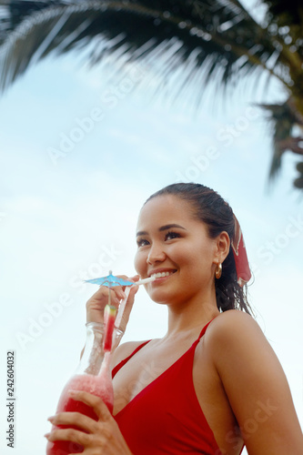 Beautiful Woman Drinking Exotic Cocktail On Beach