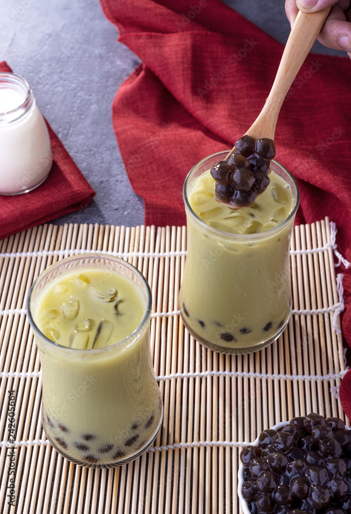 Matcha bubble tea with tapioca pearls in glasses,green tea with bubbles