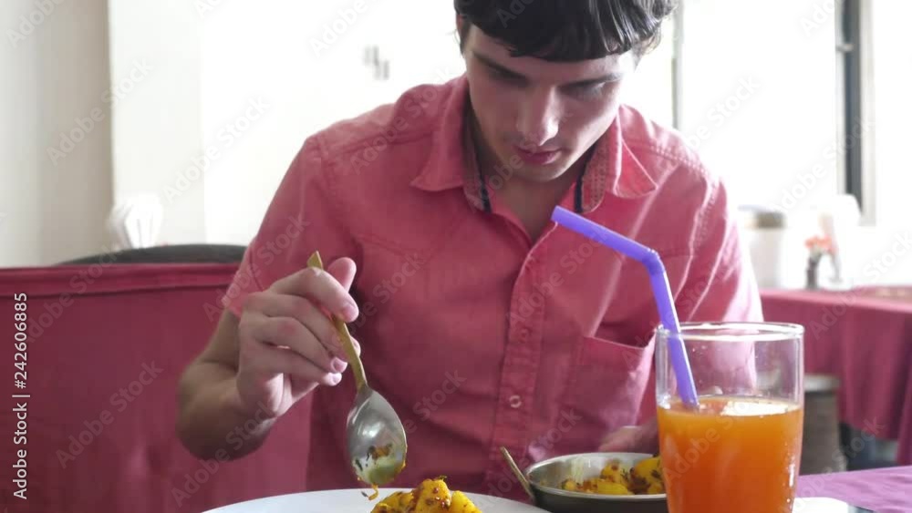Man eats chicken curry potato in indian cafe. 3840x2160 Man eats chicken curry potato in indian cafe. 3840x2160
