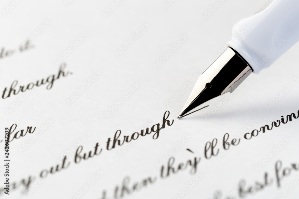 white fountain pen writing a letter