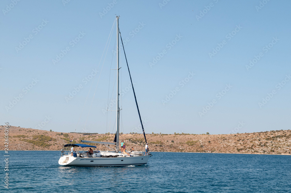 Family resting on a sailing yacht. Collapse the sail. Fold the sails. Remove the sails. After the regatta. Family resting on a sailing yacht. Collapse the sail. Fold the sails. Remove the sails. After the regatta.