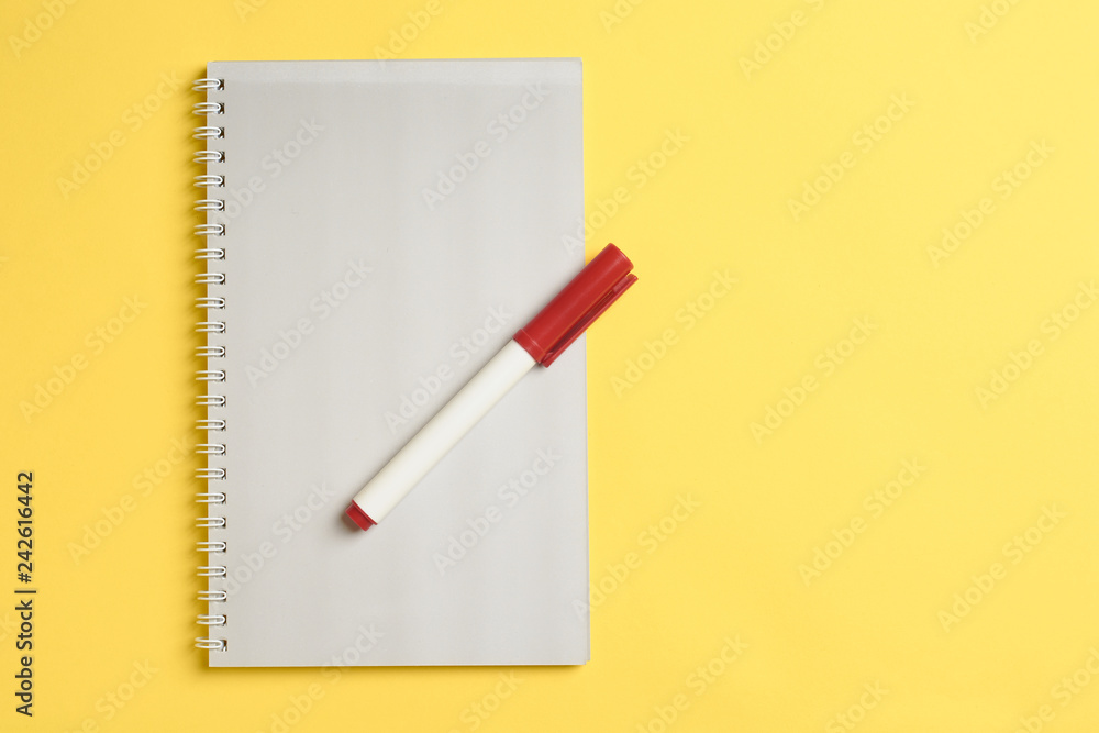 Top view of white paper blank notepad with marker on yellow paper background. Color of year 2019 Top view or flat lay. Copy space for text. Vertical. Top view of white paper blank notepad with marker on yellow paper background. Color of year 2019 Top view or flat lay. Copy space for text. Vertical.