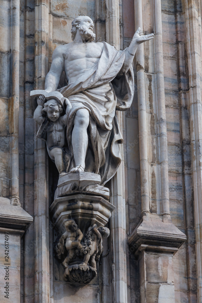 marble sculpture of the saint on the facade of Milan Cathedral Duomo