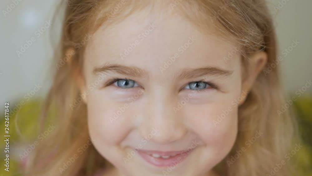 Close-up portrait of a happy little girl bursting in laugh Close-up portrait of a happy little girl bursting in laugh