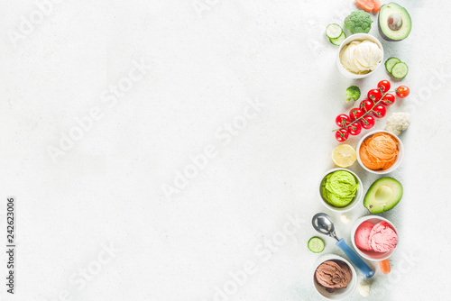 Trendy vegan food, summer healthy dessert concept, colorful diet vegetable ice cream with avocado, cucumber, tomato, beet, carrot, broccoli, cauliflower. Frozen veggie smoothie, banner