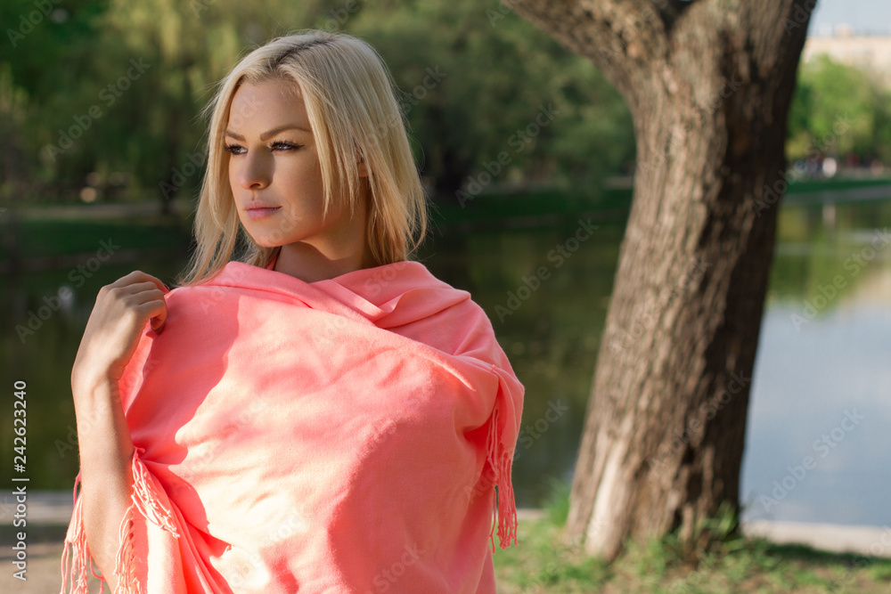 Beautiful and elegant girl in a long red dress stands in the middle of the medieval castle Beautiful and elegant girl in a long red dress stands in the middle of the medieval castle