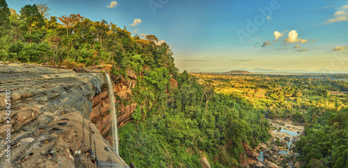 Fototapeta Naklejka Na Ścianę i Meble -  Beautiful waterfall flowing from the cliff in the tropical jungles panoramic top view