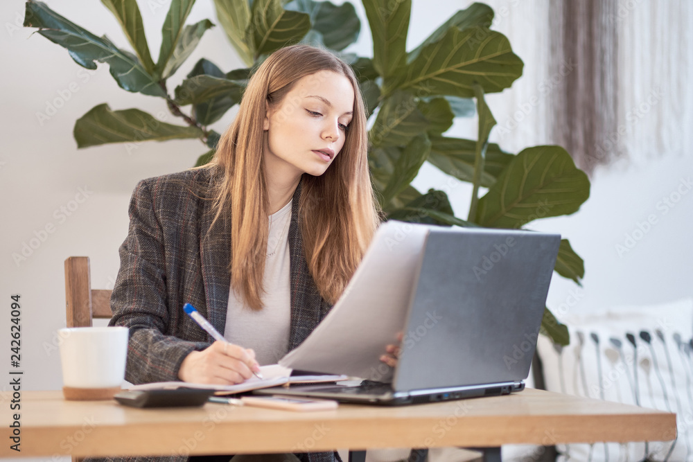 Businesswoman working with laptop, Writing something idea on notebook or check list in office Businesswoman working with laptop, Writing something idea on notebook or check list in office
