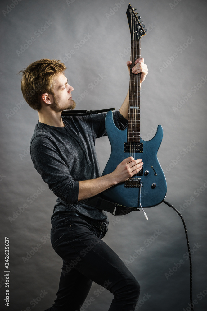 Fototapeta premium Man playing on electric guitar