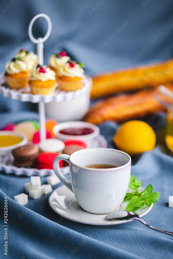 picnic. green tea in a teapot. tea in a cup. cupcakes on a plate picnic. green tea in a teapot. tea in a cup. cupcakes on a plate