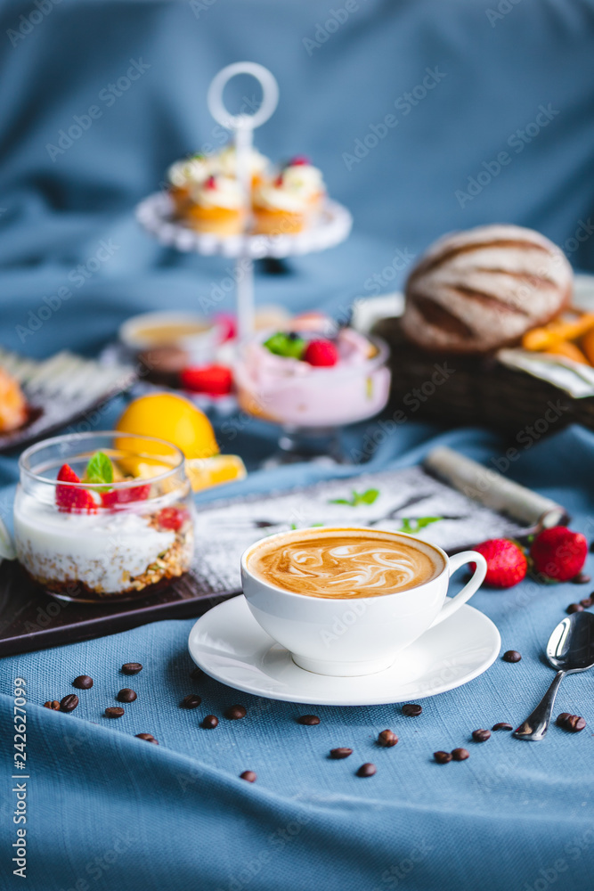 breakfast with coffee, cereal, croissant, yogurt, bread, biscuits