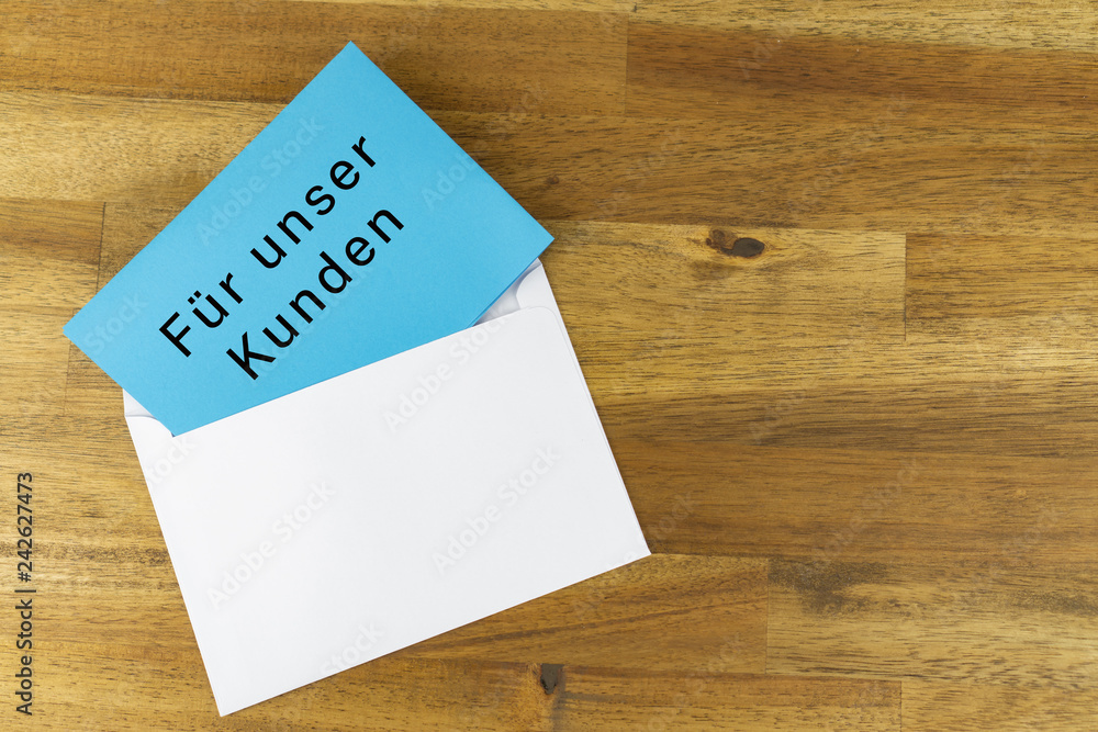 Envelope with a blue note with the german words FOR OUR CUSTOMERS Envelope with a blue note with the german words FOR OUR CUSTOMERS