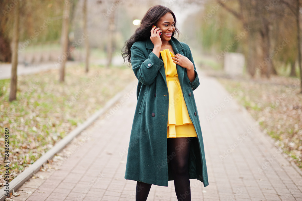 Stylish african american woman at green 