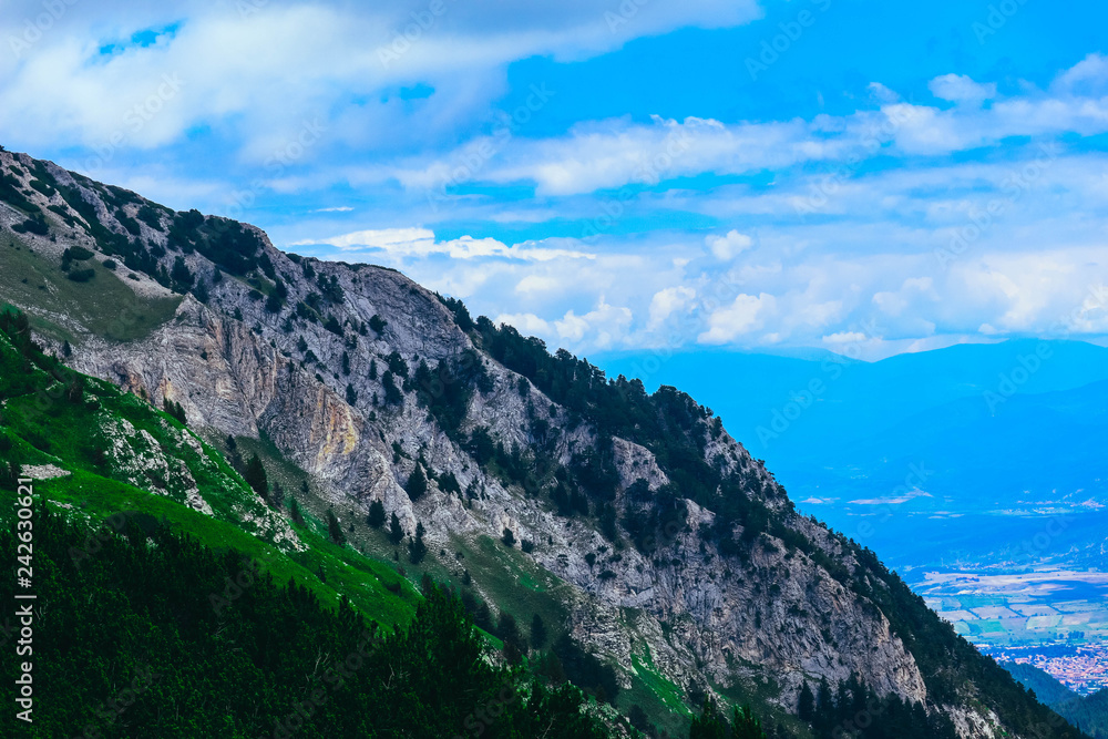 Beautiful alpine high mountains peak, blue sky background. Amazing Mountain hiking paradise landscape, summertime.