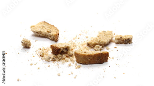 Integral toast slice with linseed and sunflower seeds crumbs isolated on white background