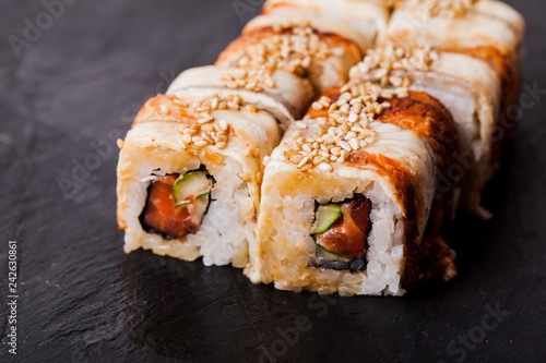 Unagi sushi roll on black slate board