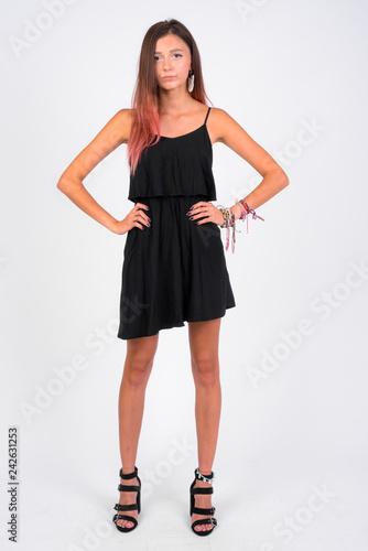 Full body shot of young beautiful woman wearing black dress © Ranta Images