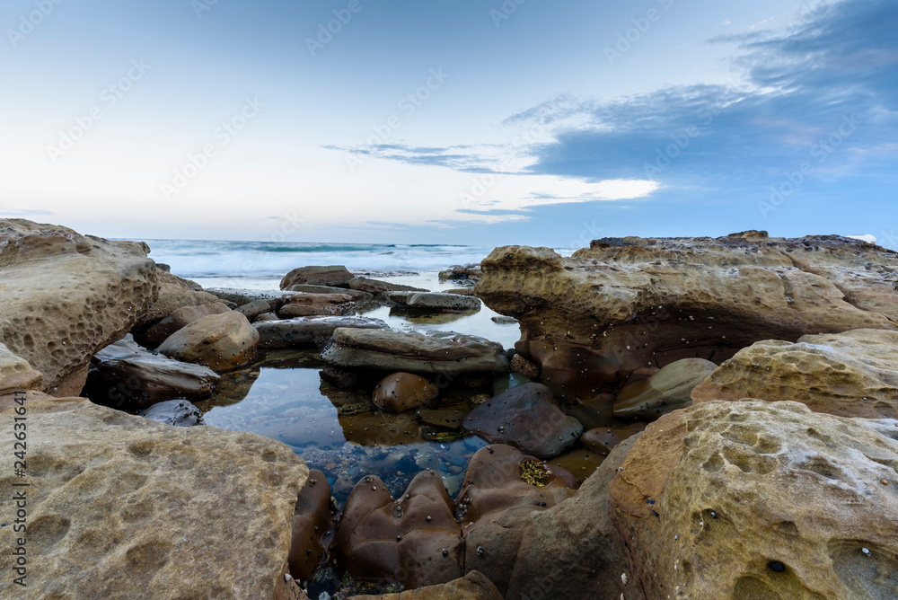 landscape with sea, rocks and blue sky with clouds in Australia