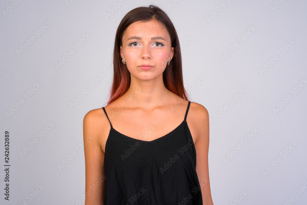 Young beautiful woman looking at camera against white background Young beautiful woman looking at camera against white background