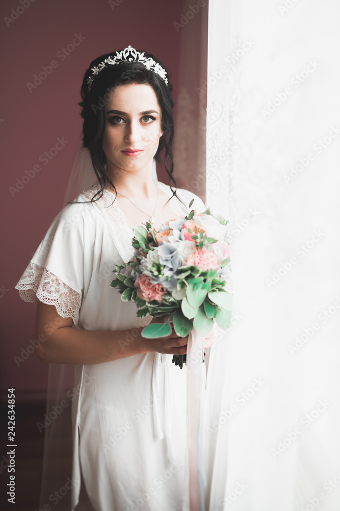 Luxury bride in white dress posing while preparing for the wedding ceremony Luxury bride in white dress posing while preparing for the wedding ceremony