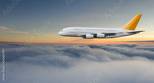 Huge two-storey passengers commercial airplane flying above dramatic clouds, sunset.