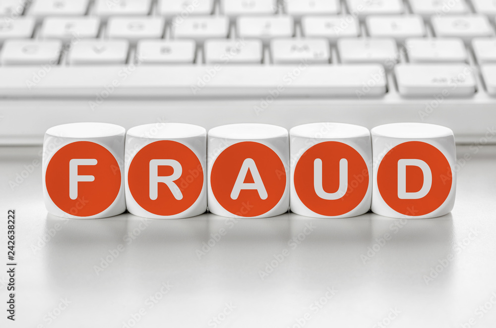 Letter dice in front of a keyboard - Fraud Letter dice in front of a keyboard - Fraud