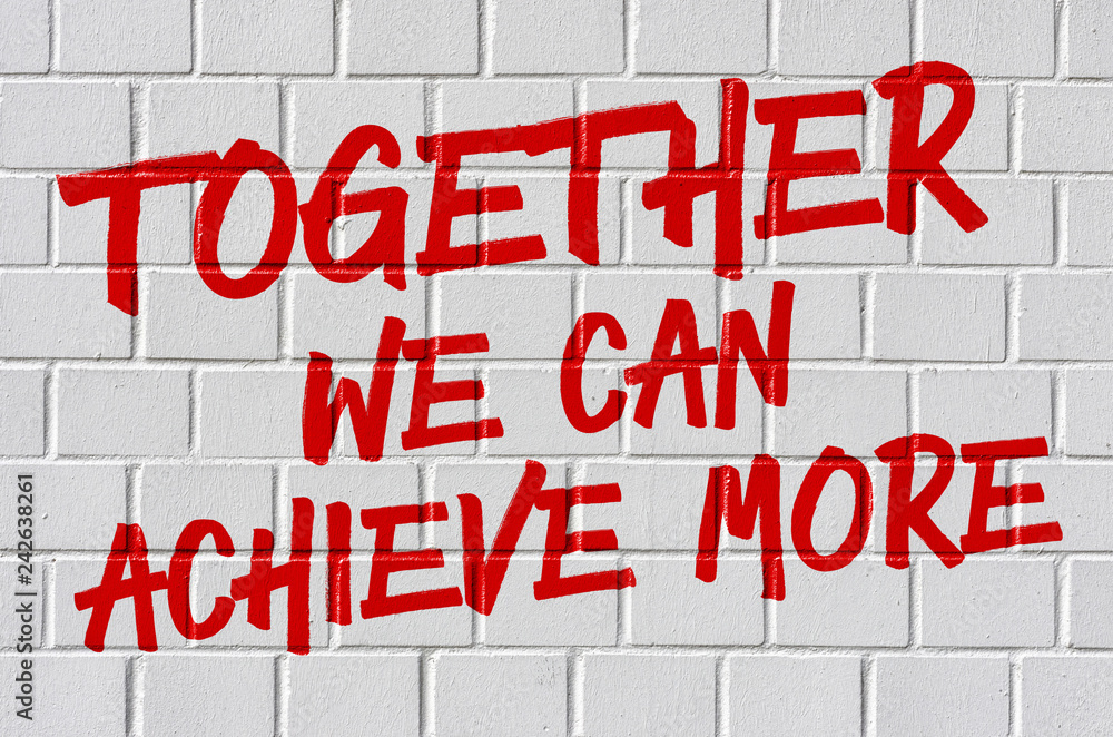 Graffiti on a brick wall - Together we can achieve more Graffiti on a brick wall - Together we can achieve more