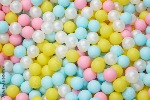 Colorful child balls. Multi-colored plastic balls. Achildren's playroom. Background texture of multi-colored plastic balls on playground