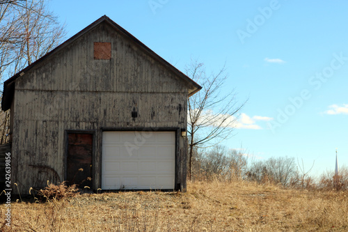 Old rustic weathered wooden barn abandoned in New England Village