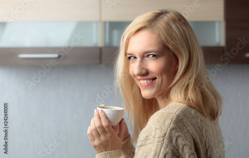 Close-up portrait of a beautiful mid age woman with cup of coffee.